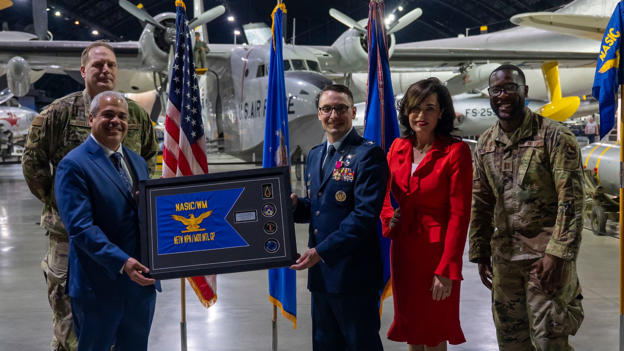The Networked Weapons and Modeling Intelligence Group (WM) leadership team presents a memento to Col. Ryan Skaggs.