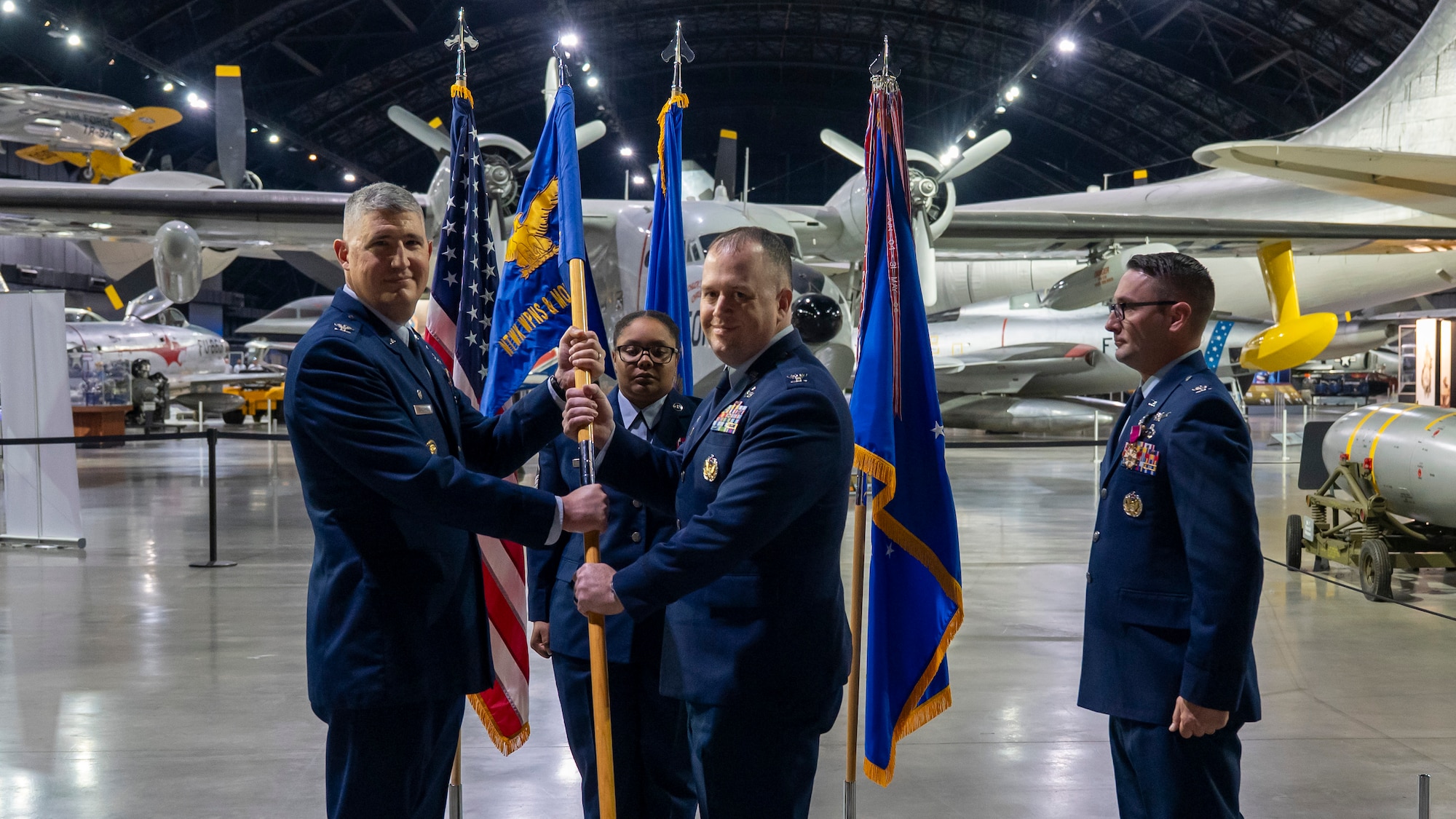 From left Col. Kenneth Stremmel passes the guidon to Col. John Minear.