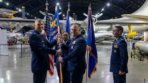From left Col. Kenneth Stremmel passes the guidon to Col. John Minear.