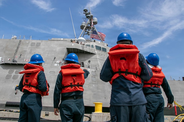 Sailors prepare to handle mooring lines as the Independence-variant littoral combat ship USS Augusta (LCS 34) arrives at Naval Station San Diego following six months of operations in the U.S. 3rd Fleet area of operations, June 11, 2026. While deployed, Augusta was the first ship to integrate U.S. Navy aviation assets, Aerosonde Uncrewed Aerial Systems, and a U.S. Coast Guard Maritime Law Enforcement Detachment on the same platform to enable multi-domain operations. Augusta is a fast, optimally manned, mission-tailored surface combatant that operates in near-shore and open-ocean environments, winning against 21st-century coastal threats. There is no substitute for presence. LCS, like Augusta, integrate with joint, combined, manned and unmanned teams to support forward presence, maritime security, sea control, and deterrence missions around the globe. (U.S. Navy photo by Mass Communication Specialist 2nd Class Kassandra Alanis)