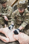 Master Sgt. Cailee Salerno demonstrated a proper chest seal application during the Health Applied Combat Medic Skills Course, Bangor, Maine, June 6, 2026. The course is designed by local medical care professionals, and enables students to proficiently execute critical life-saving techniques in a combat environment through hands-on learning and added sensory deprivation elements – a key factor for medical workers down range. Photo by Senior Master Sgt. Andrew Sinclair.