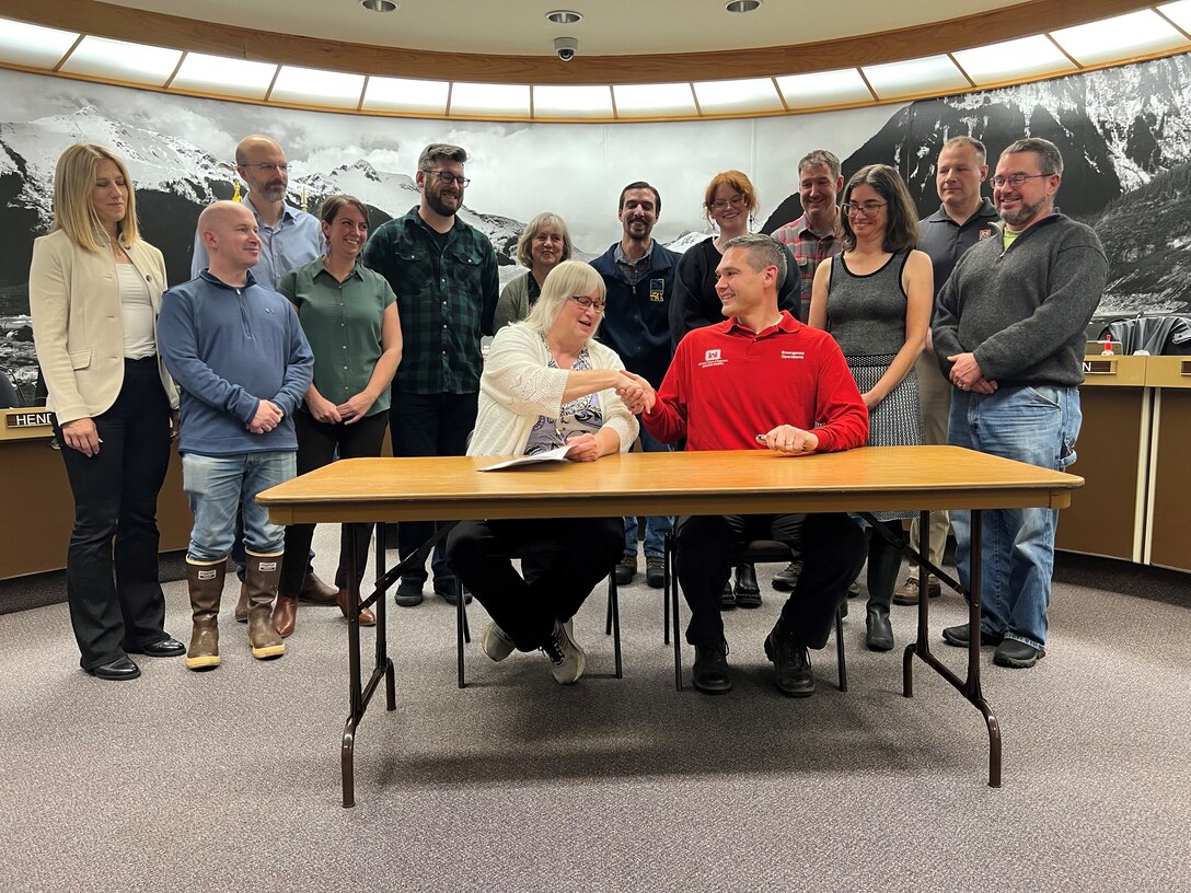 Beth Weldon, mayor of Juneau, and Daryl Downing signed the Amended Cooperative Agreement to provide Advance Measures Assistance during the October 30 Special Assembly Committee of the Whole meeting at the Assembly Chambers in Juneau.