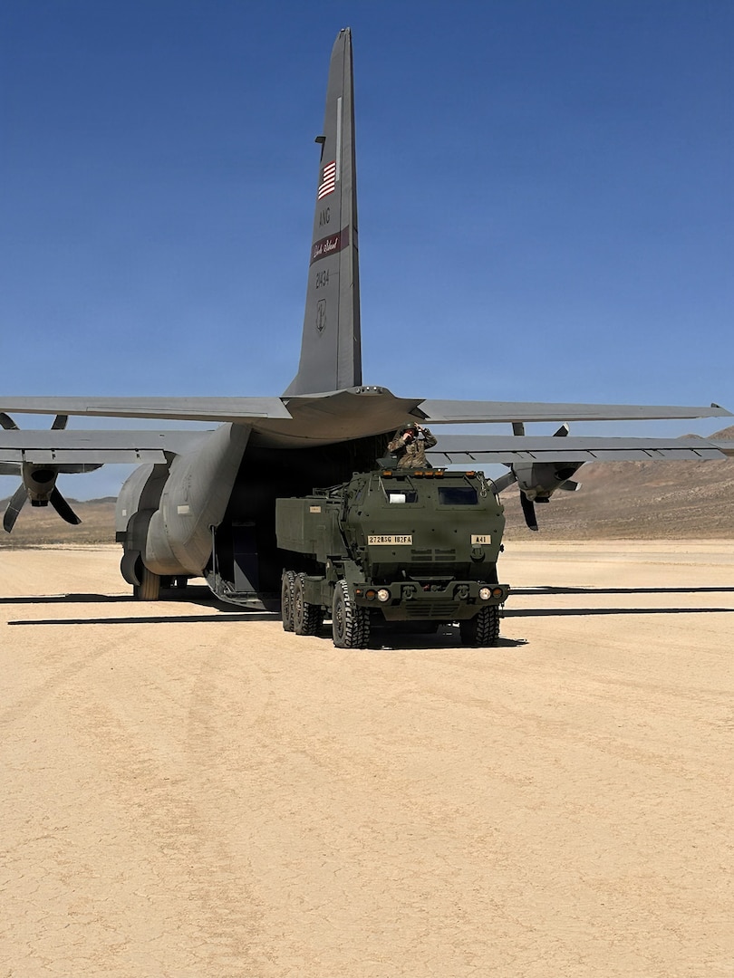 U.S. Army Soldiers with A Battery, 1st Battalion, 182nd Field Artillery Regiment, Michigan Army National Guard, roll off M142 High Mobility Artillery Rocket System, or HIMARS, from a C-130J Hercules aircraft at the National Training Center, Michigan, June 10, 2026 to conduct a HIMARS Rapid Infiltration, or HIRAIN, mission.