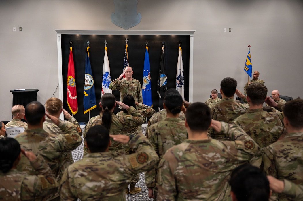 a U.S. Air Force commander is being saluted by a formation.