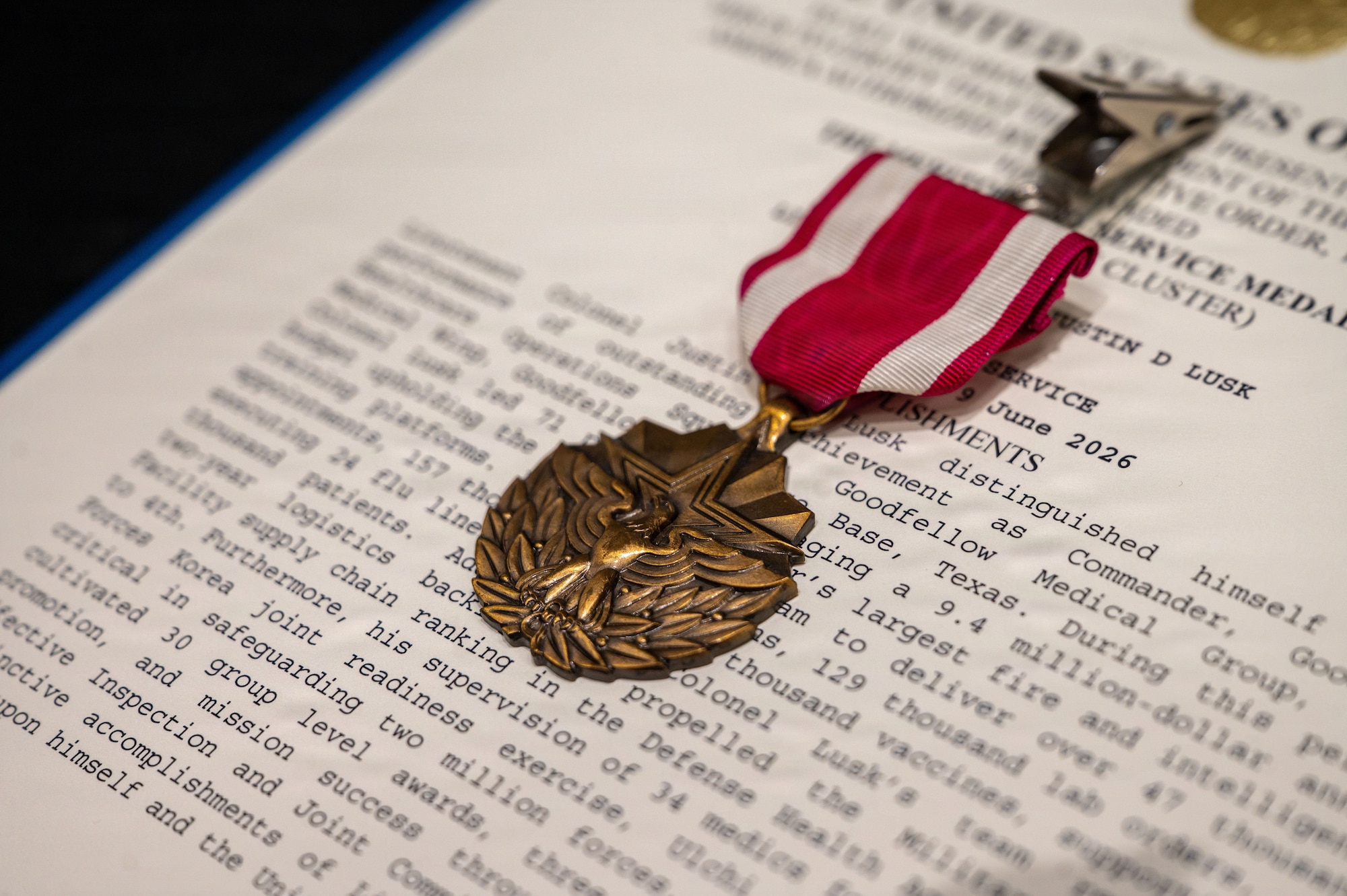 A medal sits on top of a paper decoration.