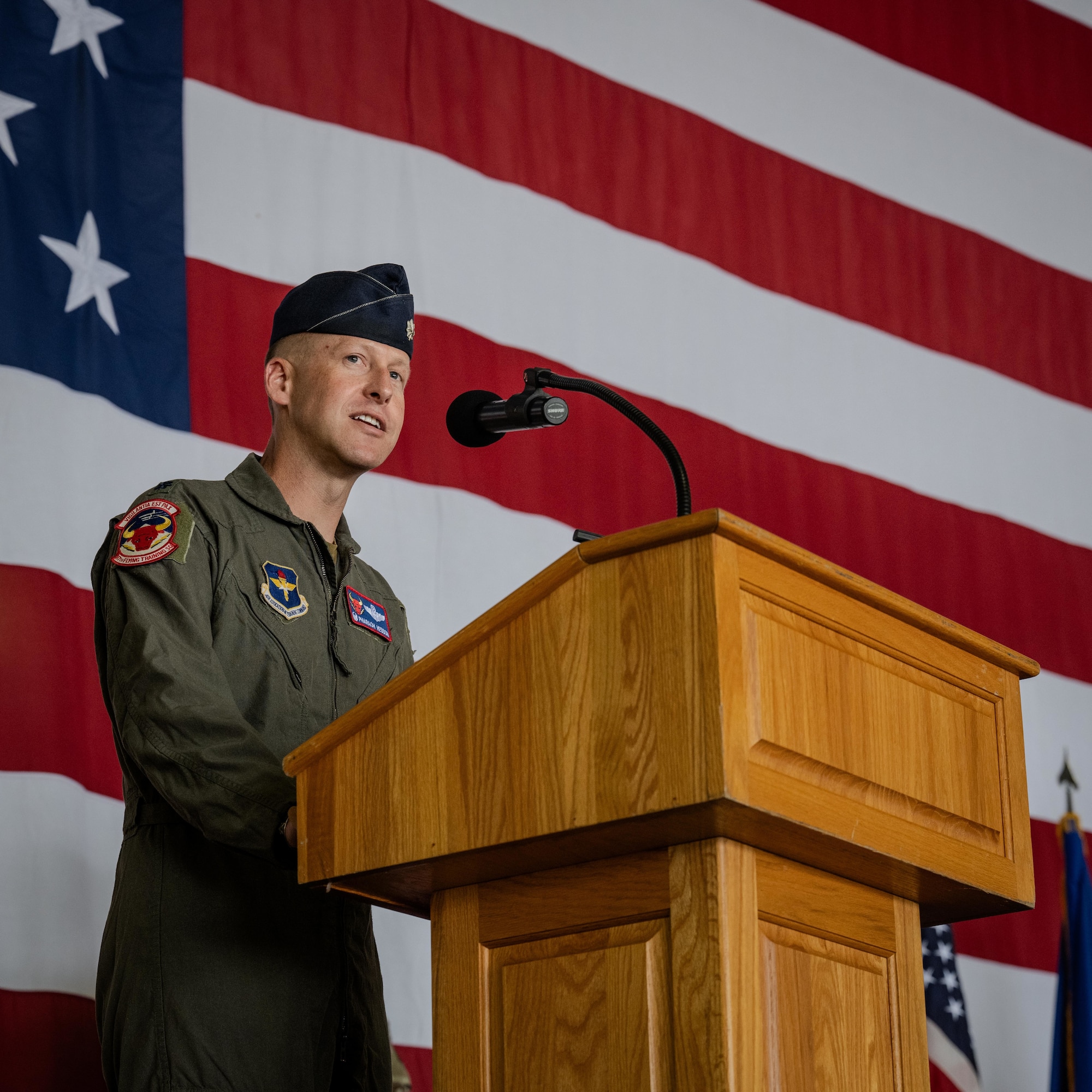 U.S. Air Force Lt. Col. James Hesson, 87th Flying Training Squadron incoming commander, gives a speech during a change of command ceremony at Laughlin Air Force Base, Texas, June 12, 2026. Hesson oversees the execution of 18K aircraft and simulator sorties and 7.2K academic events; responsible for the readiness and execution of daily flying operations for 71 aircrew, 11 support personnel, 63 aircraft worth $409M, and annually producing over 100 fighter and bomber pilots for the Combat Air Force. (U.S. Air Force photo by Airman 1st Class Harrison Sullivan)
