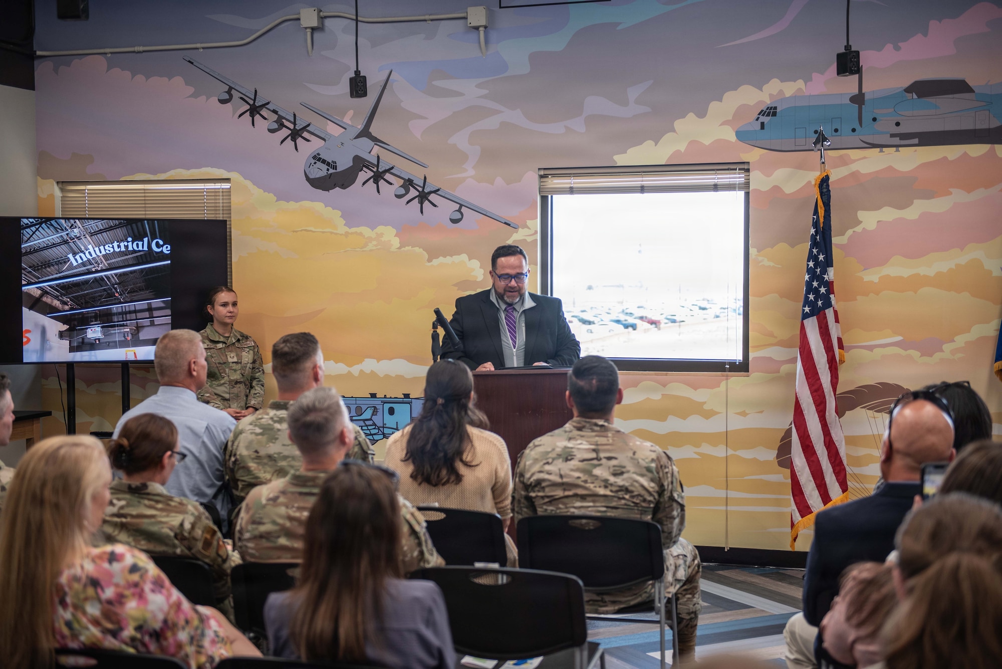 A man at a podium speaks to a crowd.