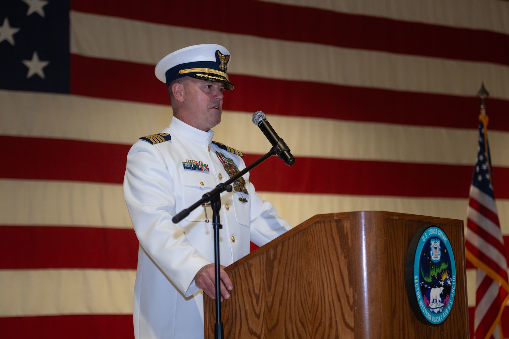 U.S. Coast Guard Capt. Joel Carse, sector commander of Sector Western Alaska and U.S. Arctic, speaks at a change of command ceremony at Joint Base Elmendorf-Richardson, Alaska, June 12, 2026.