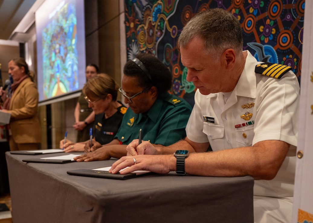Rear Adm. Sonya Bennett, Commander Joint Health and Surgeon General, Australian Defence Force, Major Roselyne Wia, Papua New Guinea Defence Force, Director of Health Services, and Capt. Peter Roberts, U.S. Indo-Pacific Command, Command Surgeon, sign Terms of Reference at the Indo-Pacific health security alliance summit in Kuala Lumpur, Malaysia, June 8, 2026.