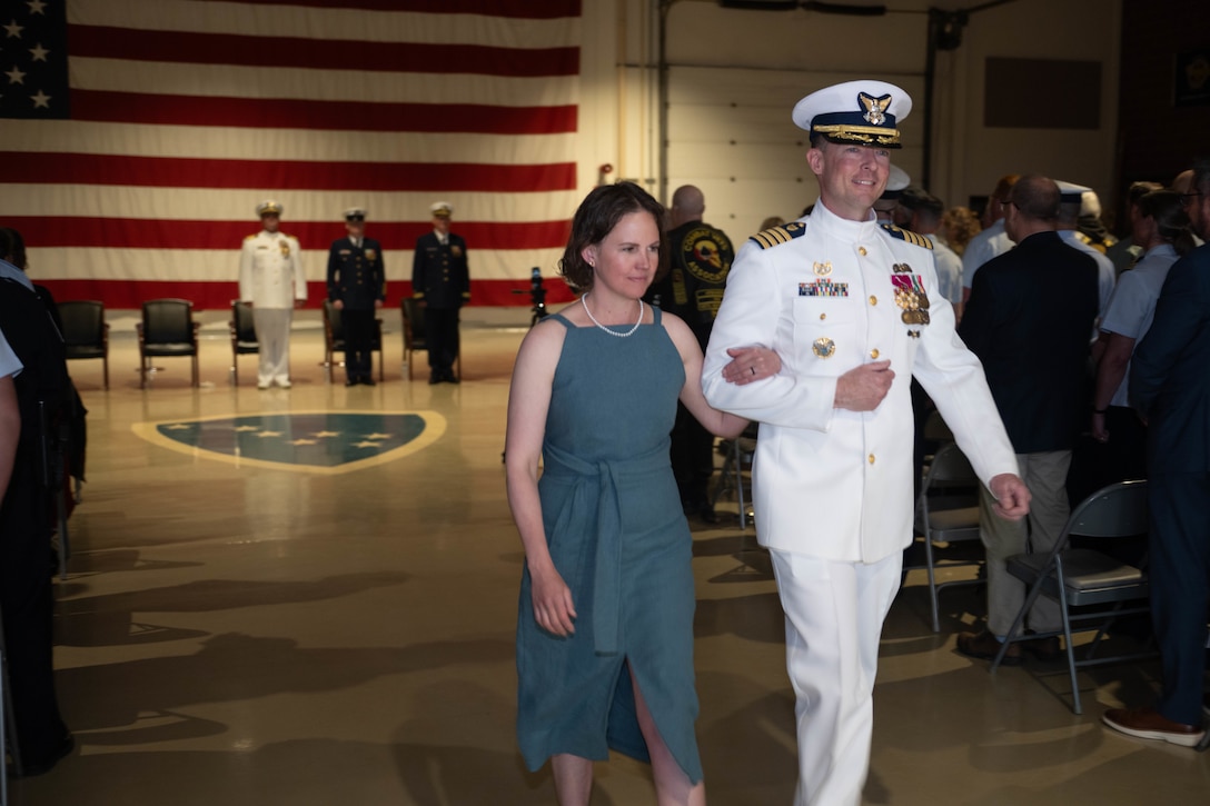 U.S. Coast Guard Capt. Christopher Culpepper, former sector commander of Sector Western Alaska and U.S. Arctic, walks his wife down the aisle after the conclusion of the change of command ceremony at Joint Base Elmendorf-Richardson, Alaska, June 12, 2026.