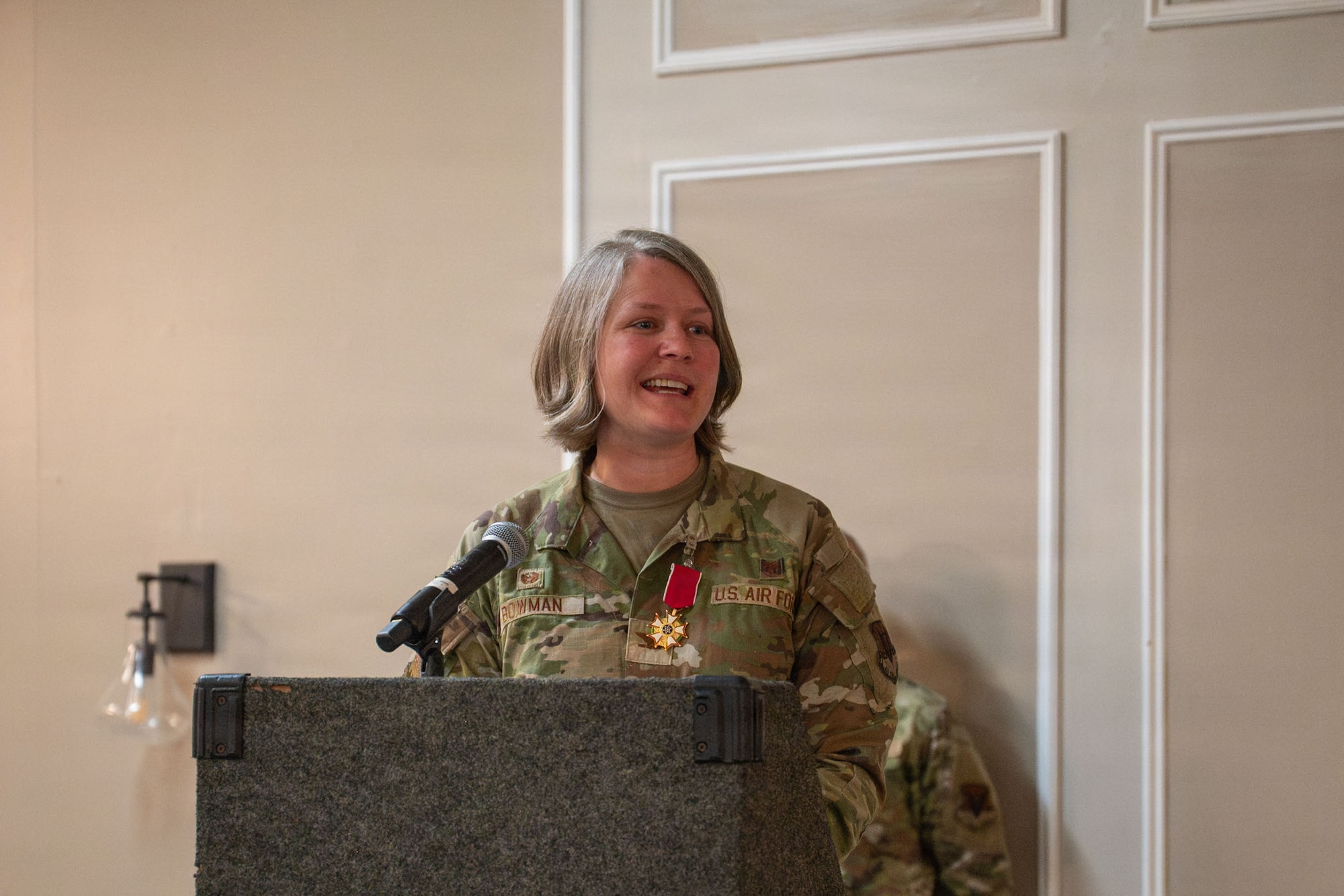 An Airman speaks at a podium