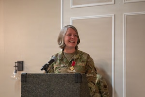 An Airman speaks at a podium