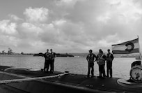 Crew members stand atop Virginia-class fast-attack submarine USS Colorado (SSN 788) following its return from sea trials during a maintenance period at Joint Base Pearl Harbor-Hickam, June 6, 2026. Pearl Harbor Naval Shipyard and Intermediate Maintenance Facility (PHNSY & IMF) and Colorado’s crew completed the scheduled maintenance period on June 10, 2026, 29 days ahead of schedule, returning to the fleet lethal and ready to defend the nation. Commissioned March 17, 2018, at Naval Submarine Base New London, Colorado is the 15th Virginia-class fast-attack submarine and fifth Block III submarine of the class. Colorado is assigned to Submarine Squadron 7 and is capable of supporting various missions, including anti-submarine warfare; anti-surface ship warfare; strike warfare; special operations forces support; and intelligence, surveillance, and reconnaissance. PHNSY & IMF's mission is to keep the Navy's fleet "Fit to Fight" by repairing, maintaining, and modernizing the Navy's fast-attack submarines and surface ships. Strategically located in the heart of the Pacific, it is the most comprehensive fleet repair and maintenance facility between the U.S. West Coast and the Far East. (US Navy photo illustration by Claudia LaMantia)

This image was created in color and changed to black-and-white.