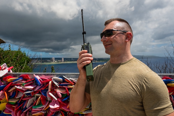 U.S. Air Force Staff Sgt. Marcin Drozd, 439th Aeromedical Evacuation Squadron expeditionary communication technician, communicates over an AN/PRC-163 multi-channel handheld radio during Cyber Guam 2026 in Tamuning, Guam, June 4, 2026.