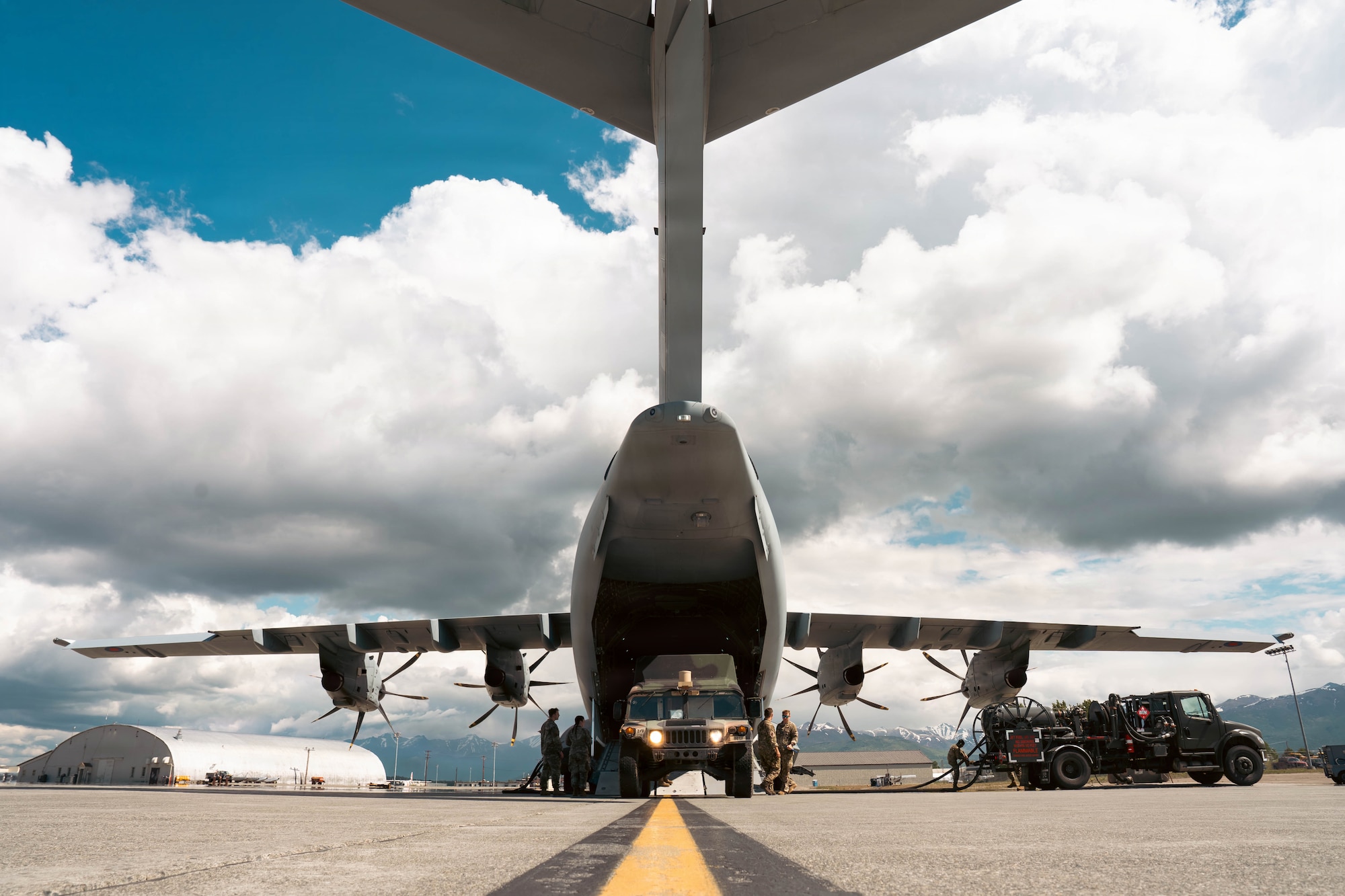 A U.S. Army, 11th Airbourne Divison Humvee is loaded onto a Royal Air Force Airbus A400M Atlas aircraft assigned to No. 70 Squadron during RED FLAG-Alaska 26-2 at Joint Base Elmendorf-Richardson, Alaska, June 10, 2026. The exercise brought together U.S., United Kingdom, Canadian and New Zealand forces to improve integration and strengthen multinational partnerships. (U.S. Air Force photo by Airman 1st Class Keola Vischi)
