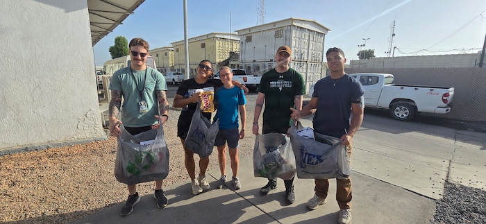 Air National Guardsmen take a photo with locals while volunteering at a orphanage during their deployment in Djibouti, Feb. 21. Members of the 130th Airlift Wing set up a medical clinic to assist with wound care for the local populace.