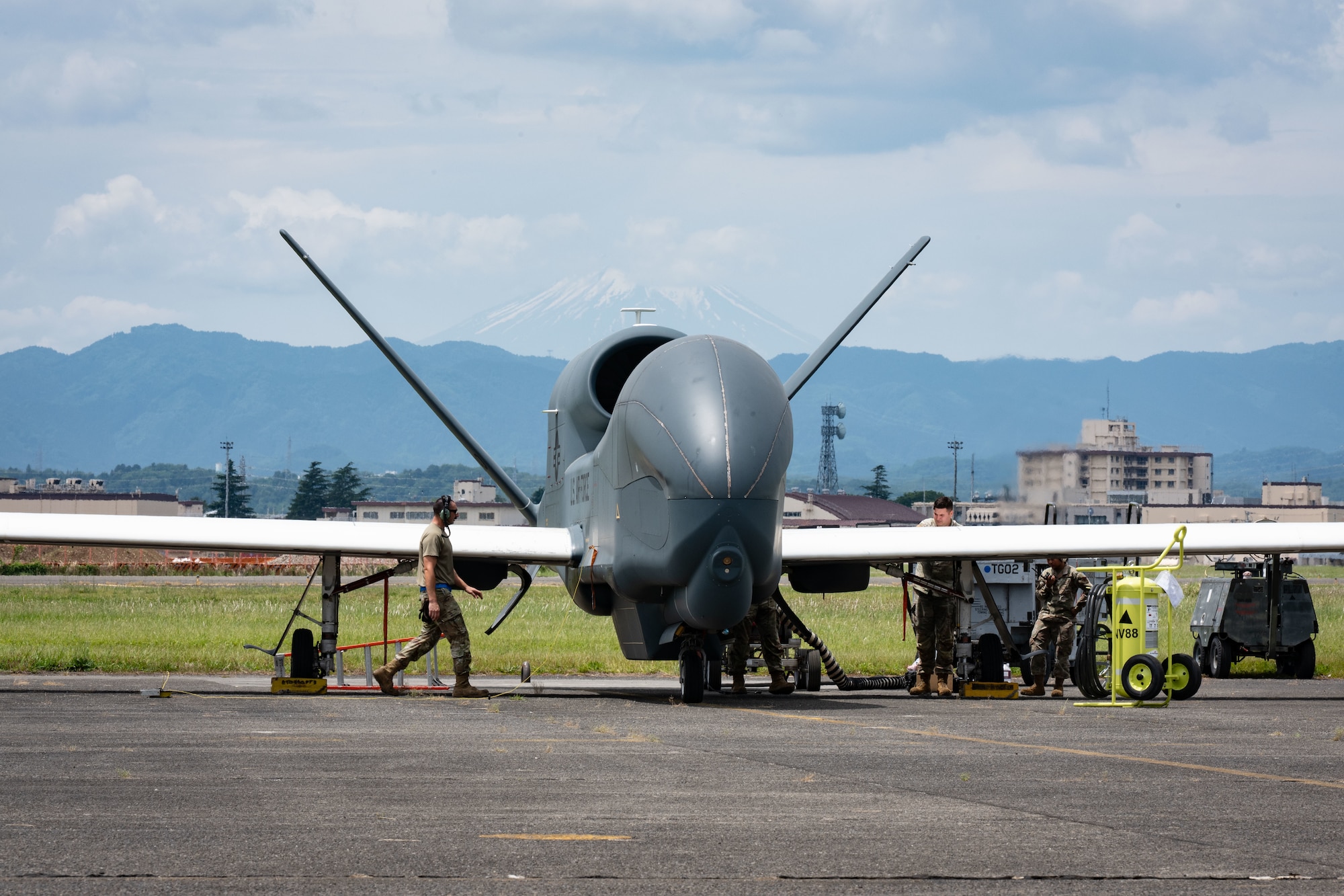 A military drone stands static on a flightline