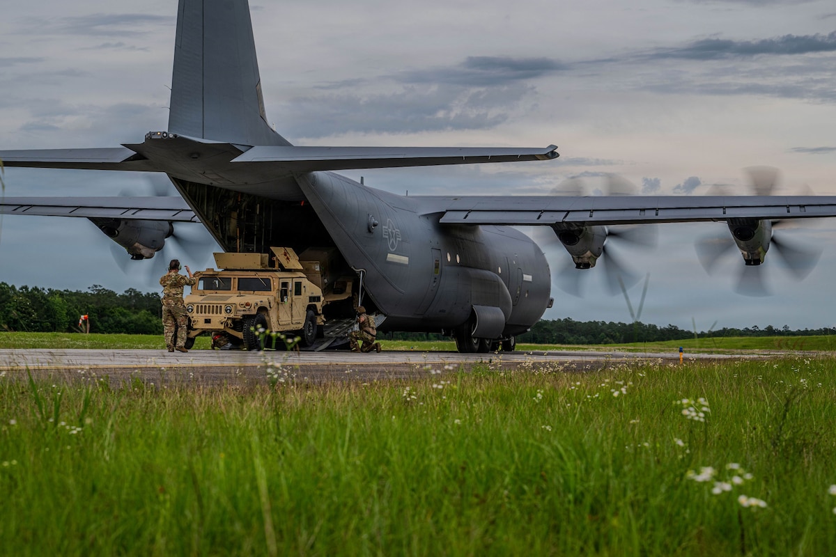 Men unload a plane.