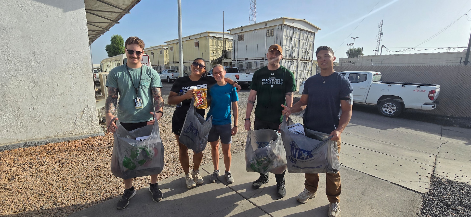 Air National Guardsmen take a photo with locals while volunteering at a orphanage during their deployment in Djibouti, Feb. 21. Members of the 130th Airlift Wing set up a medical clinic to assist with wound care for the local populace.