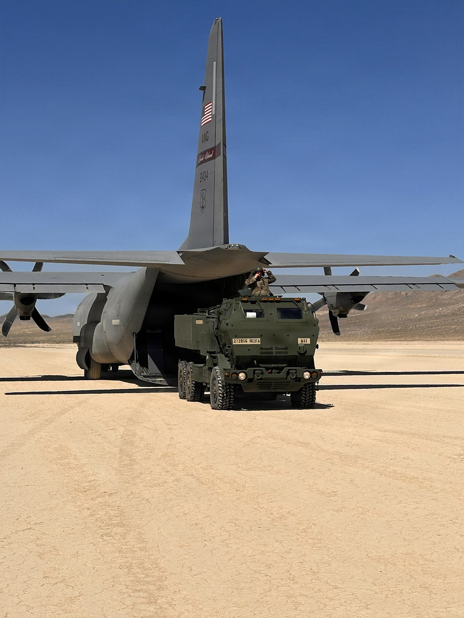 U.S. Army Soldiers with A Battery, 1st Battalion, 182nd Field Artillery Regiment, Michigan Army National Guard, roll off M142 High Mobility Artillery Rocket System, or HIMARS, from a C-130J Hercules aircraft at the National Training Center, Michigan, June 10, 2026 to conduct a HIMARS Rapid Infiltration, or HIRAIN, mission.