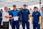 Lt. Hayden Carter (second from left), commanding officer of USCGC Jeffrey Palazzo (WPC 1163), shakes hands with Allen Harker (left), contracting officer for the Fast Response Cutter Project, during an acceptance ceremony in Key West, Florida, on June 11, 2026. The cutter is named for Jeffrey Palazzo, a New York City firefighter and U.S. Coast Guard reservist who made the ultimate sacrifice on Sept. 11, 2001, while responding to the attacks on the World Trade Center. (U.S. Coast Guard photo by Ensign Carly Logan)
