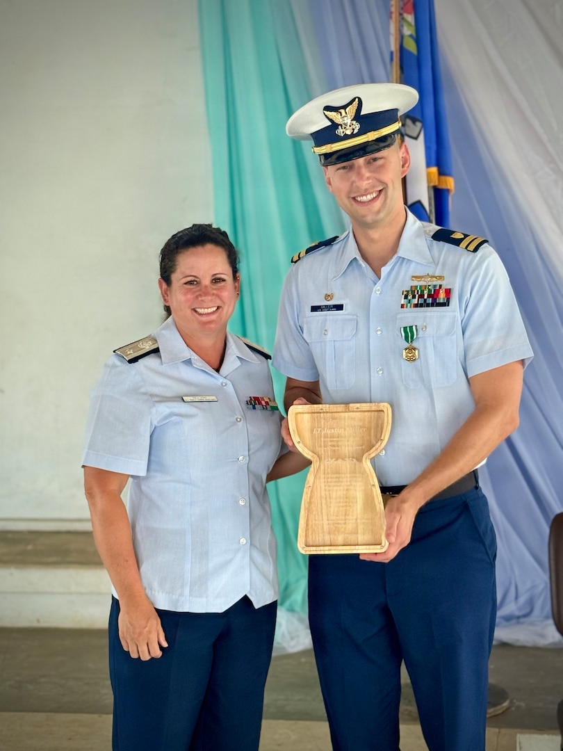Lt. Justin Miller stands for a photo with Commodore Jodi Nelson of the Oceania District U.S. Coast Guard Auxiliary during a change of command ceremony for Marine Safety Unit Saipan in Saipan, Commonwealth of the Northern Mariana Islands, on June 13, 2026. During Miller's tenure from October 2023 to June 2026, MSU Saipan stood up as a full Marine Safety Unit — elevated from Marine Safety Detachment Saipan on April 5, 2024 — and matured into the Coast Guard's permanent prevention and response presence across the Commonwealth. Under his leadership, the unit advanced maritime safety, security, and environmental stewardship through vessel inspections, port state control examinations, container inspections, and continuous engagement with port partners and local leaders. The U.S. Coast Guard Auxiliary in Saipan also found renewed life and an increase in membership. (U.S. Coast Guard photo by Dee Cruz)