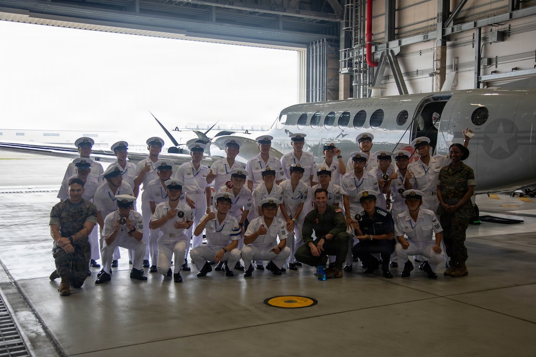 Japanese Maritime Self-Defense Force cadets and U.S. Marines with Headquarters and Headquarters Squadron (H&HS), Marine Corps Air Station Iwakuni, pose for a photo in front of a UC-12W Huron aircraft assigned to H&HS, MCAS Iwakuni, during an installation tour at MCAS Iwakuni, Japan, June 9, 2026. The tour gave JMSDF cadets an opportunity to engage with U.S. Marines and Sailors at MCAS Iwakuni and better understand the installation’s capabilities. (U.S. Marine Corps photo by Lance Cpl. Rylan Adcock)
