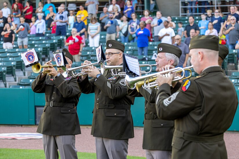 From left to right, Chief Warrant Officer 5, Staff Sgt. Brian Bull, Sgt. 1st Class Chris Hartsock, Sgt. 1st Class Joel Heredia, and Master Sgt. Robert Leatherbee, all with the U.S. Army Recruiting Operations Division, play the Star-Spangled Banner before an Indianapolis Indians baseball game at Victory Field in Indianapolis June 12, 2026. The Indians paid special tribute to the 251st birthdays of both the U.S. Army and Army Finance Corps. (U.S. Army photo by Mark R. W. Orders-Woempner)
