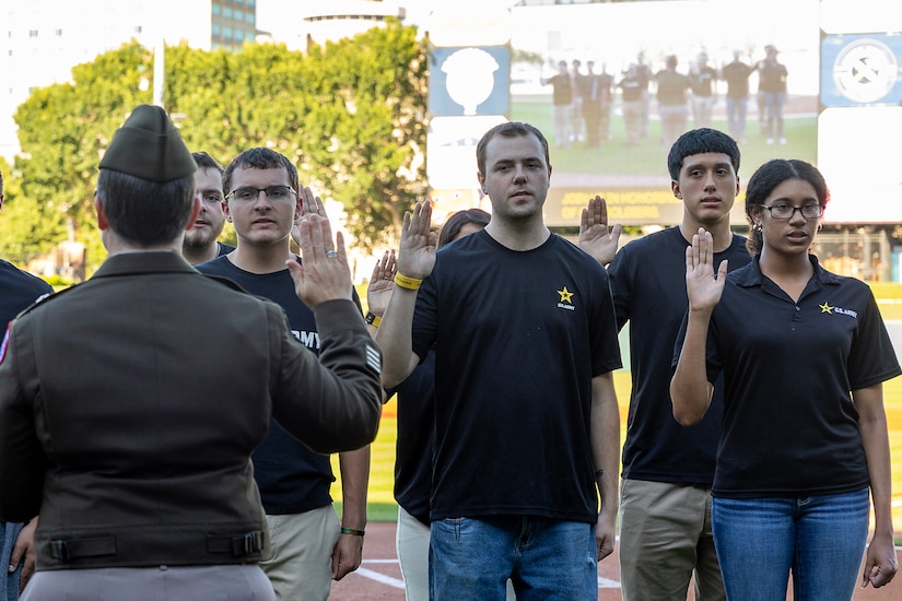 Brig. Gen. Sara Dudley, U.S. Army Recruiting Division commanding general, administers the Oath of Enlistment to 16 Future Soldiers before an Indianapolis Indians baseball game at Victory Field in Indianapolis June 12, 2026. The Indians paid special tribute to the 251st birthdays of both the U.S. Army and Army Finance Corps. (U.S. Army photo by Mark R. W. Orders-Woempner)