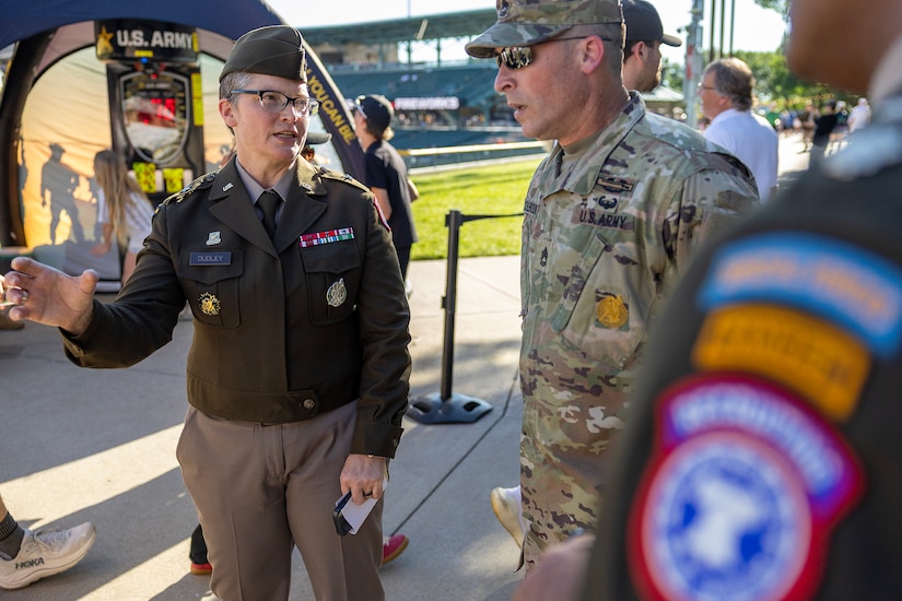 Brig. Gen. Sara Dudley, U.S. Army Recruiting Division commanding general, talks with Sgt. 1st Class Heath Colbourne, U.S. Army Indianapolis Recruiting Battalion station commander, and Lt. Col. Kerry Zanders, Indianapolis Recruiting Battalion commander, before an Indianapolis Indians baseball game at Victory Field in Indianapolis June 12, 2026. The Indians paid special tribute to the 251st birthdays of both the U.S. Army and Army Finance Corps. (U.S. Army photo by Mark R. W. Orders-Woempner)