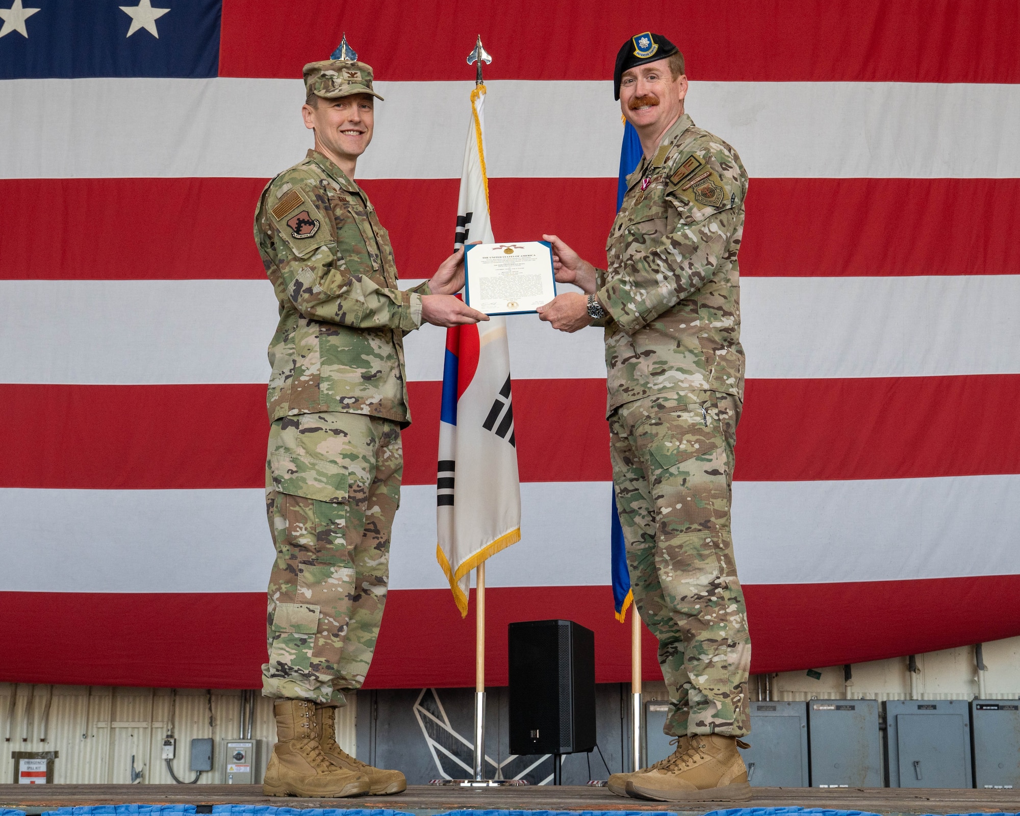 U.S. Air Force Lt. Col. Ryan Kiggins, 8th Security Forces Squadron outgoing commander, right, receives the Meritorious Service Medal from U.S. Air Force Col. Timothy Frank, 8th Mission Support Group commander, during the 8th SFS change of command ceremony at Kunsan Air Base, Republic of Korea, June 12, 2026. The event recognized the outgoing commander's service while welcoming the incoming commander to the unit. (U.S. Air Force photo by Staff Sgt. Cedrique Oldaker)