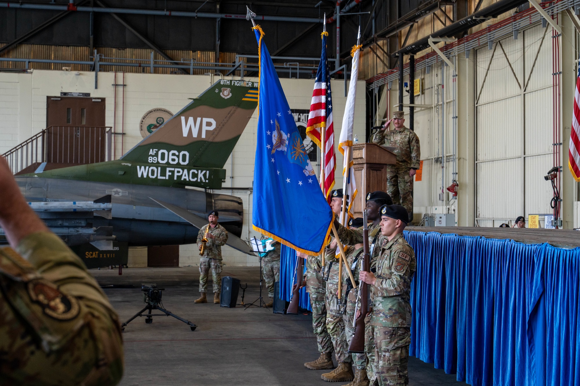 U.S. Air Force Maj. Adam Palmer, 8th Security Forces Squadron incoming commander, right, receives the guidon from U.S. Air Force Col. Timothy Frank, 8th Mission Support Group commander, left, during the 8th SFS change of command ceremony at Kunsan Air Base, Republic of Korea, June 12, 2026. The passing of the guidon symbolizes the preservation of military heritage and the seamless transition of leadership that has strengthened America's armed forces for 250 years. (U.S. Air Force photo by Staff Sgt. Cedrique Oldaker)