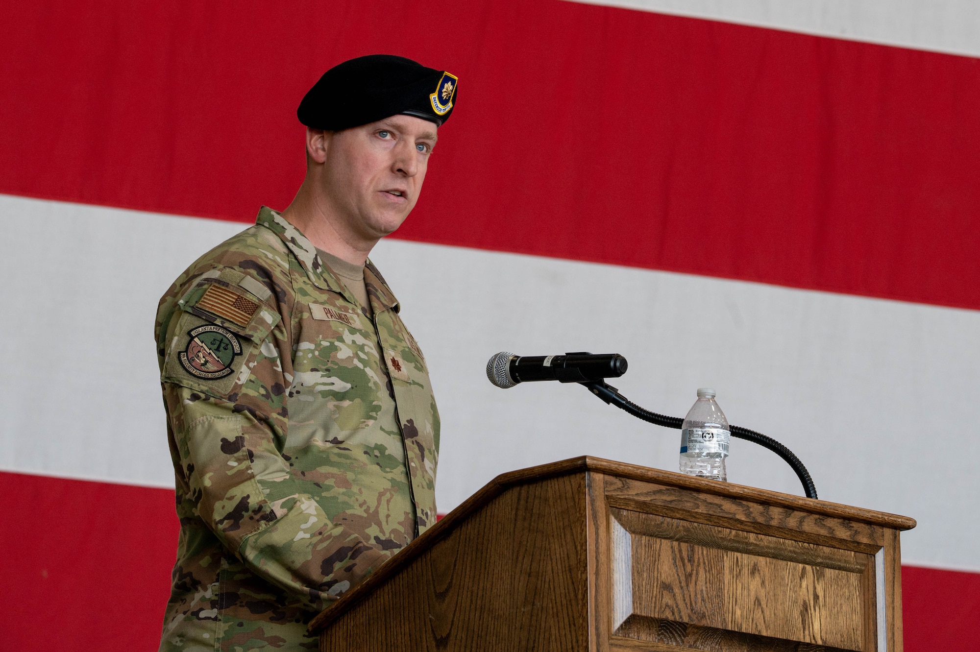 U.S. Air Force Maj. Adam Palmer, 8th Security Forces Squadron incoming commander, gives his remarks during the 8th SFS change of command ceremony at Kunsan Air Base, Republic of Korea, June 12, 2026. During his speech, Palmer congratulated the leadership of the outgoing commander and expressed enthusiasm in leading the dedicated Airmen of the Wolf Pack. (U.S. Air Force photo by Staff Sgt. Cedrique Oldaker)