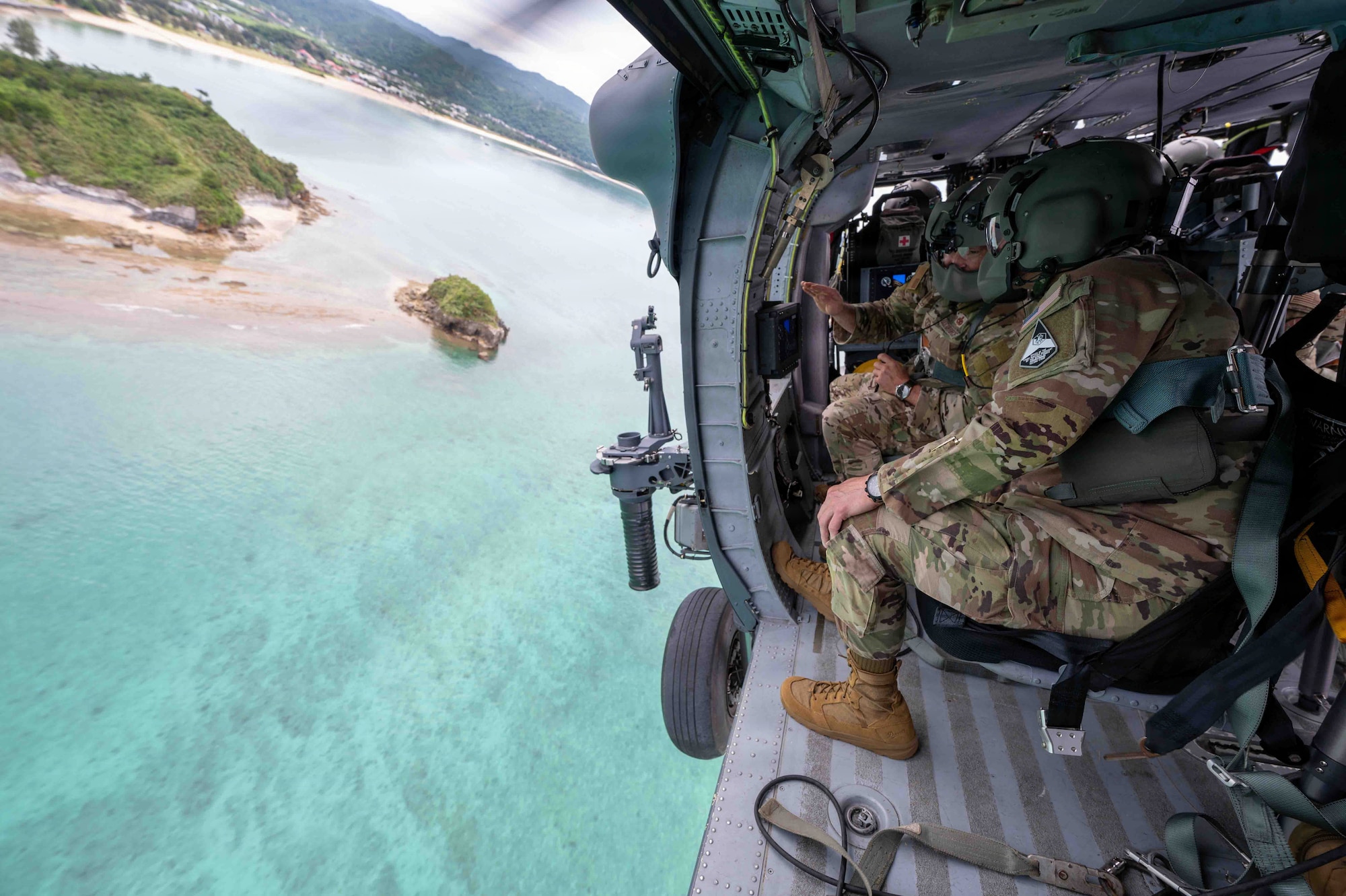 Chief Master Sgt. of the Space Force John Bentivegna speaks with U.S. Air Force Chief Master Sgt. Will Cupp, 18th Wing command chief, during a flight in an HH-60W Jolly Green II assigned to the 33rd Rescue Squadron at Kadena Air Base, Japan, June 12, 2026. The immersion offered a closer look at the people and capabilities that support the 18th Wing's mission. (U.S. Air Force photo by Airman 1st Class Arnet Tamayo)