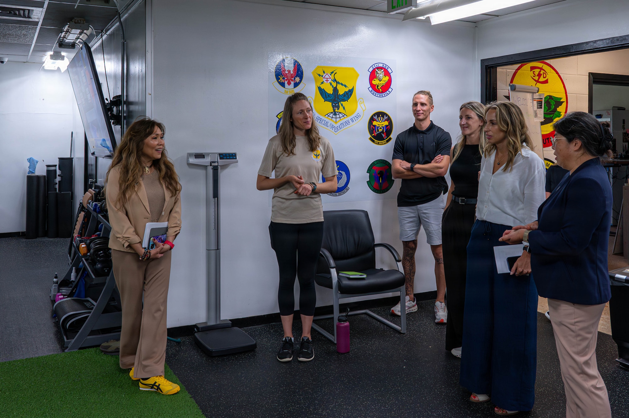 Cathy Bentivegna, left, spouse of Chief Master Sgt. of the Space Force John Bentivegna, and key spouses at Kadena are introduced to the 353rd Special Operations Wing’s physical training facility at Kadena Air Base, Japan, June 12, 2026. Each stop highlighted programs that strengthen family readiness and quality of life across the installation. (U.S. Air Force photo by Senior Airman Amy Kelley)