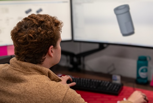 man looks at scan of boom to drogue adapter