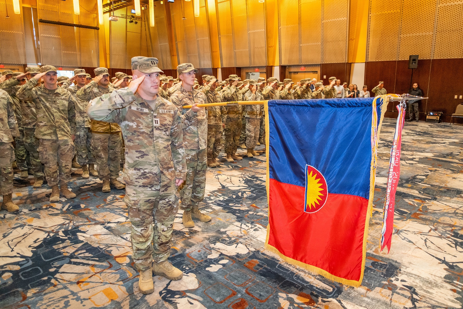 Capt. Nathan Scull, formation commander, salutes as the 234th Army Band, Oregon Army National Guard, plays the national anthem during an official demobilization ceremony at the Salem Convention Center in Salem, Ore., June 14, 2026.