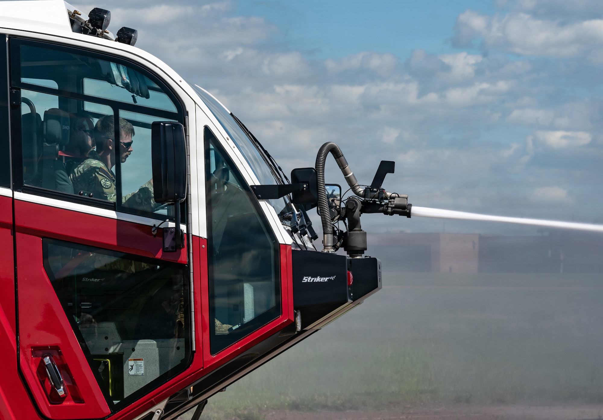 Capt. Timothy Lenihan, commander of Montana Army National Guard firefighting detachments, operates the mounted turret of an aircraft rescue firefighting vehicle during a joint training exercise at the 120th Airlift Wing in Great Falls, Montana, June 11, 2026.