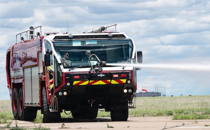 Soldiers assigned to Montana Army National Guard firefighting detachments operate an aircraft rescue firefighting vehicle during a joint live-fire training exercise at the 120th Airlift Wing in Great Falls, Montana, June 11, 2026.