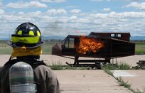 A firefighter observes a live-fire aircraft training simulator during a joint aircraft rescue firefighting exercise at the 120th Airlift Wing in Great Falls, Montana, June 11, 2026.