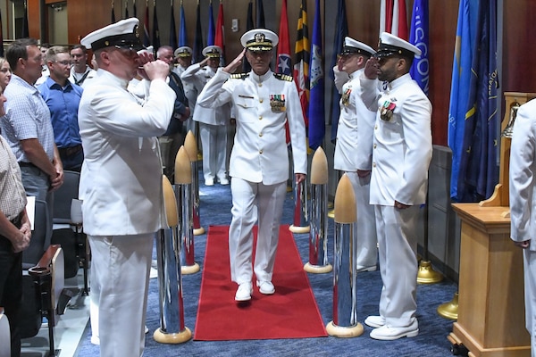 Navy Capt. Afshin Afarin, center, took command of Navy Medicine Readiness and Training Command Great Lakes June 12 in a ceremony at the Capt. James A. Lovell Federal Health Care Center in North Chicago, Ill.