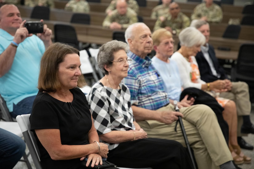 Family members look on as Lt. Col. Michael Sharp speaks during a promotion ceremony at the Boone National Guard Center in Frankfort, April 24.