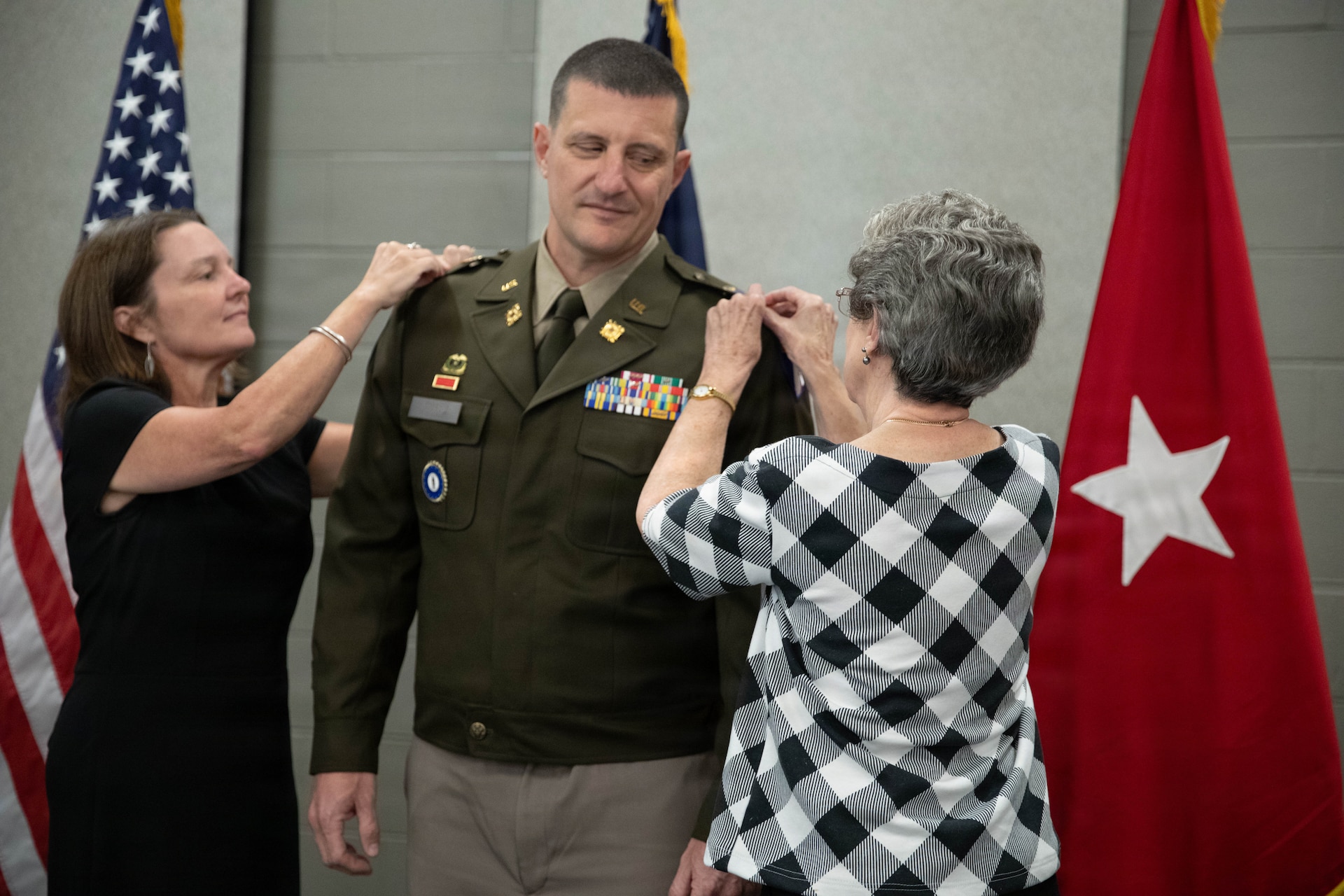 U.S. Army Lt. Col. Michael Sharp is pinned with his new rank by his wife and his mother during a promotion ceremony at the Boone National Guard Center in Frankfort, April 24.