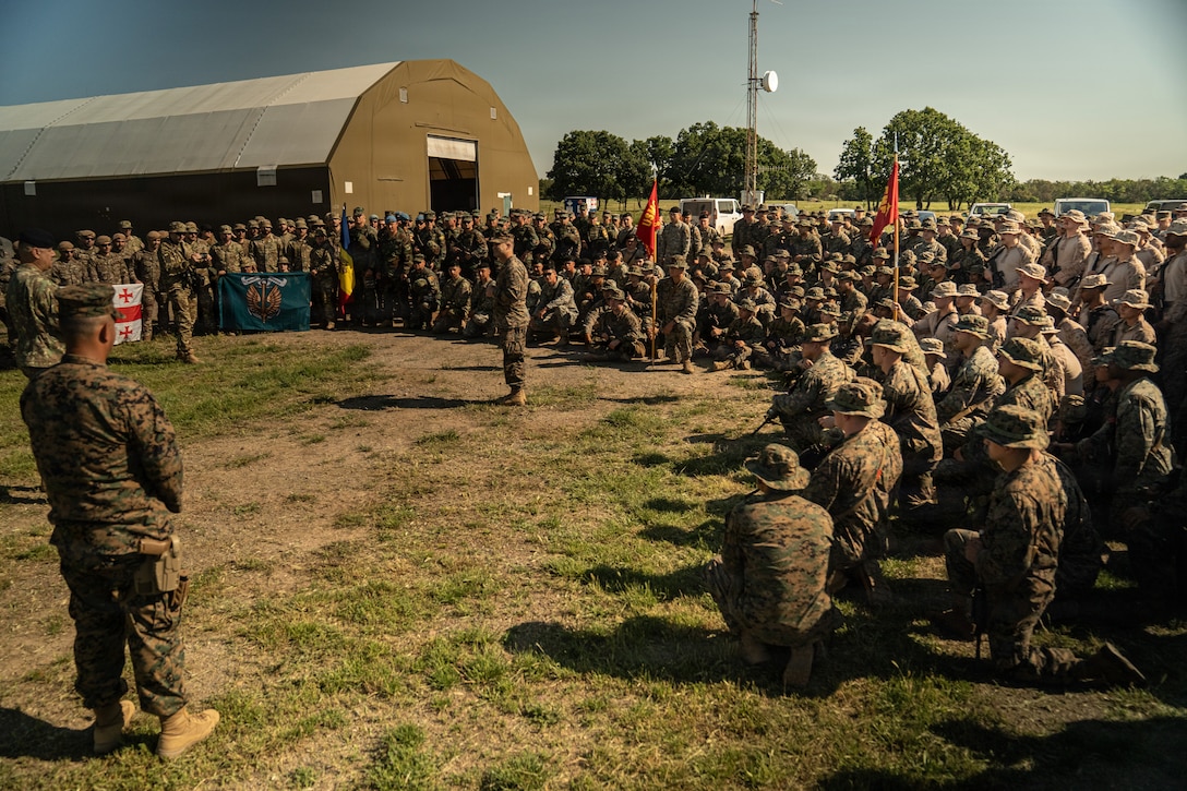 U.S. Marine Corps Lt. Col. Nishan Campbell, the commanding officer of 4th Assault Amphibian Battalion, 4th Marine Division, addresses Marines and NATO partners during the opening ceremony of exercise Sea Breeze 26 at Babadag Training Area, Romania, June 10, 2026. Sea Breeze 26 is an annual exercise co-sponsored by U.S. Naval Forces Europe-Africa and Marine Corps Forces Europe-Africa, designed to develop interoperability of maritime and ground forces in the Black Sea Region through combined NATO deliberate planning, integration, and command and control of Marine Amphibious Forces. (U.S. Marine Corps photo by Sgt. Noah Masog)