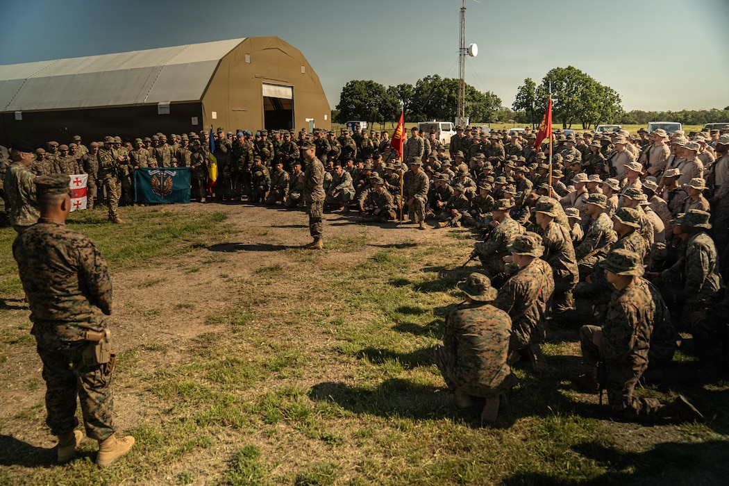 U.S. Marine Corps Lt. Col. Nishan Campbell, the commanding officer of 4th Assault Amphibian Battalion, 4th Marine Division, addresses Marines and NATO partners during the opening ceremony of exercise Sea Breeze 26 at Babadag Training Area, Romania, June 10, 2026. Sea Breeze 26 is an annual exercise co-sponsored by U.S. Naval Forces Europe-Africa and Marine Corps Forces Europe-Africa, designed to develop interoperability of maritime and ground forces in the Black Sea Region through combined NATO deliberate planning, integration, and command and control of Marine Amphibious Forces. (U.S. Marine Corps photo by Sgt. Noah Masog)
