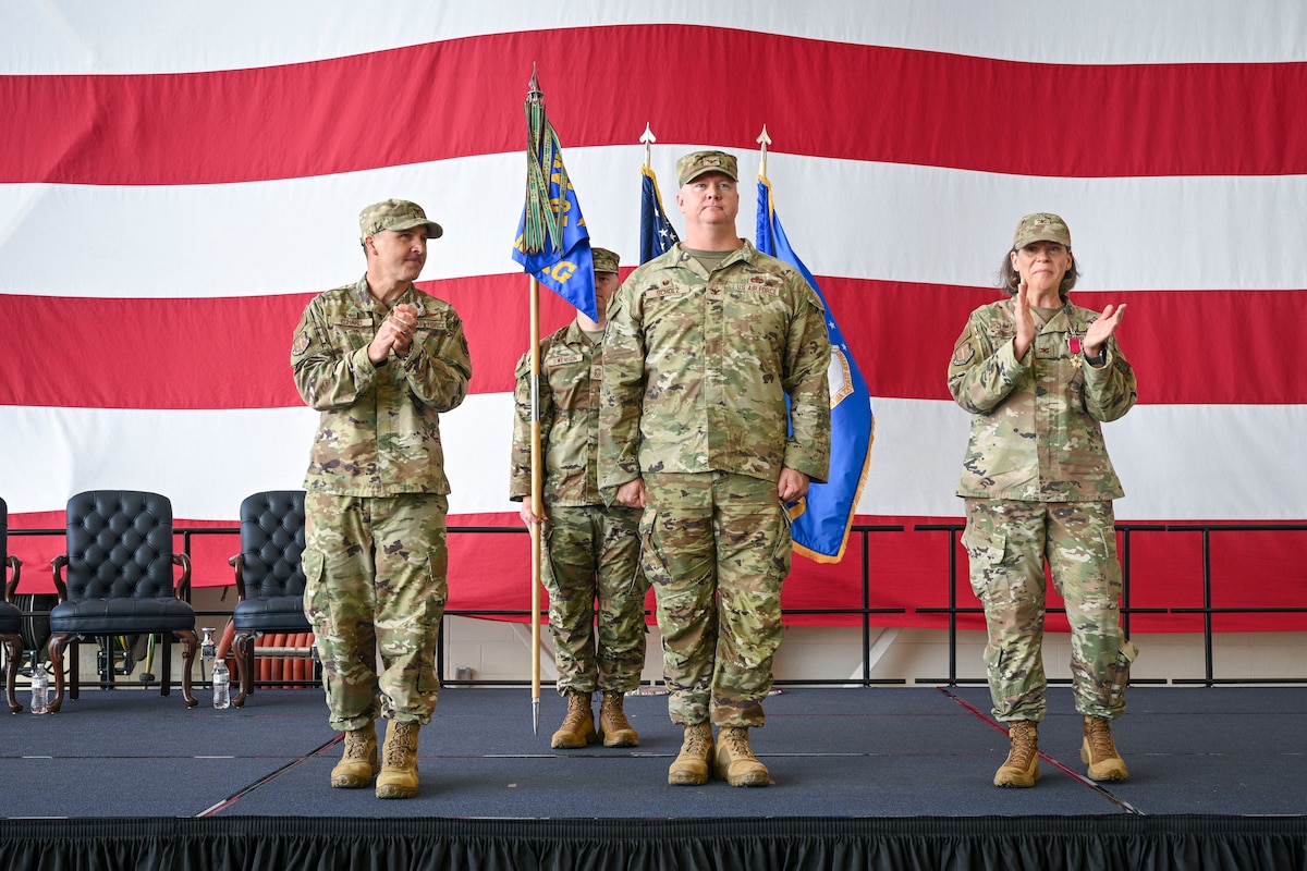 U.S. Air Force Col. Kevin Scholz receives applause during a change of command ceremony.