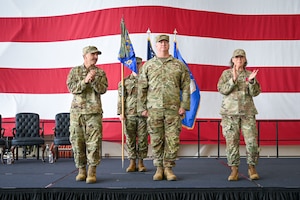 U.S. Air Force Col. Kevin Scholz receives applause during a change of command ceremony.