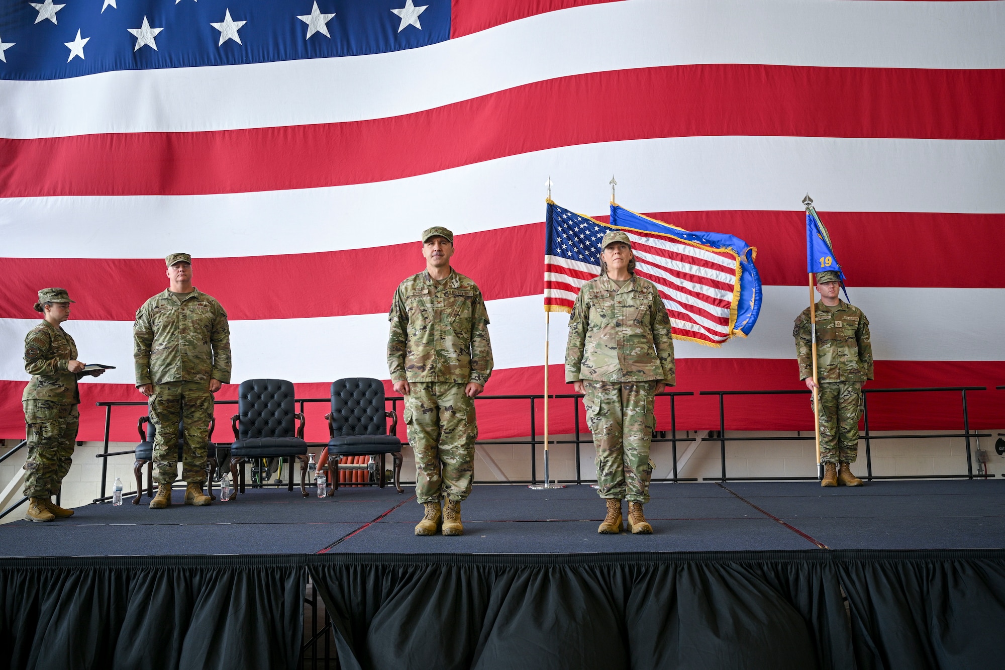 Col. Bret Echard, and Col. Amanda Sheets, stand at attention during a ceremony.