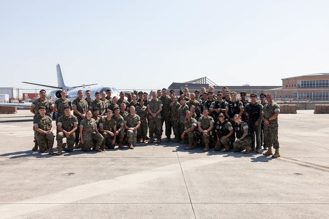 The 39th Commandant of the Marine Corps, Gen. Eric M. Smith, and Sgt. Maj. Carlos A. Ruiz, the 20th Sergeant Major of the Marine Corps, pose for a photo with Marines assigned to the 2nd Marine Aircraft Wing and Marine Corps Air Station Cherry Point at MCAS Cherry Point, North Carolina, June 11, 2026. Gen. Smith and Sgt. Maj. Ruiz traveled to Marine Corps Air Station Cherry Point to tour military facilities, engage with and recognize Marines, Sailors, and civilians for superior performance, and receive operational updates from key leaders. (U.S. Marine Corps photo by Lance Cpl. Orlanys Diaz Figueroa)