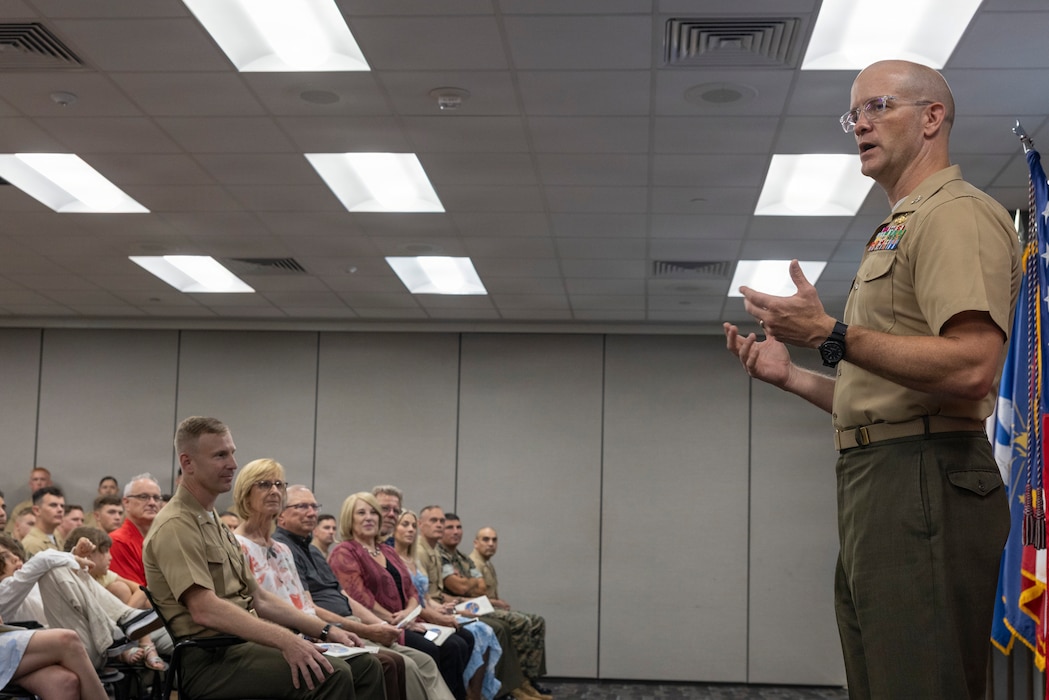 U.S. Marine Corps Col. Ian Fletcher, the Commanding Officer of II Marine Expeditionary Force Information Group, speaks to Marines and family members during the 2nd Air Naval Gunfire Liaison Company Change of Command ceremony at Marine Corps Base Camp Lejeune, North Carolina, June 11, 2026. The change of command ceremony symbolizes the passing of authority and responsibility from the offgoing to the oncoming commanding officer. (U.S. Marine Corps photo by Lance Cpl. Sabine Wilson)